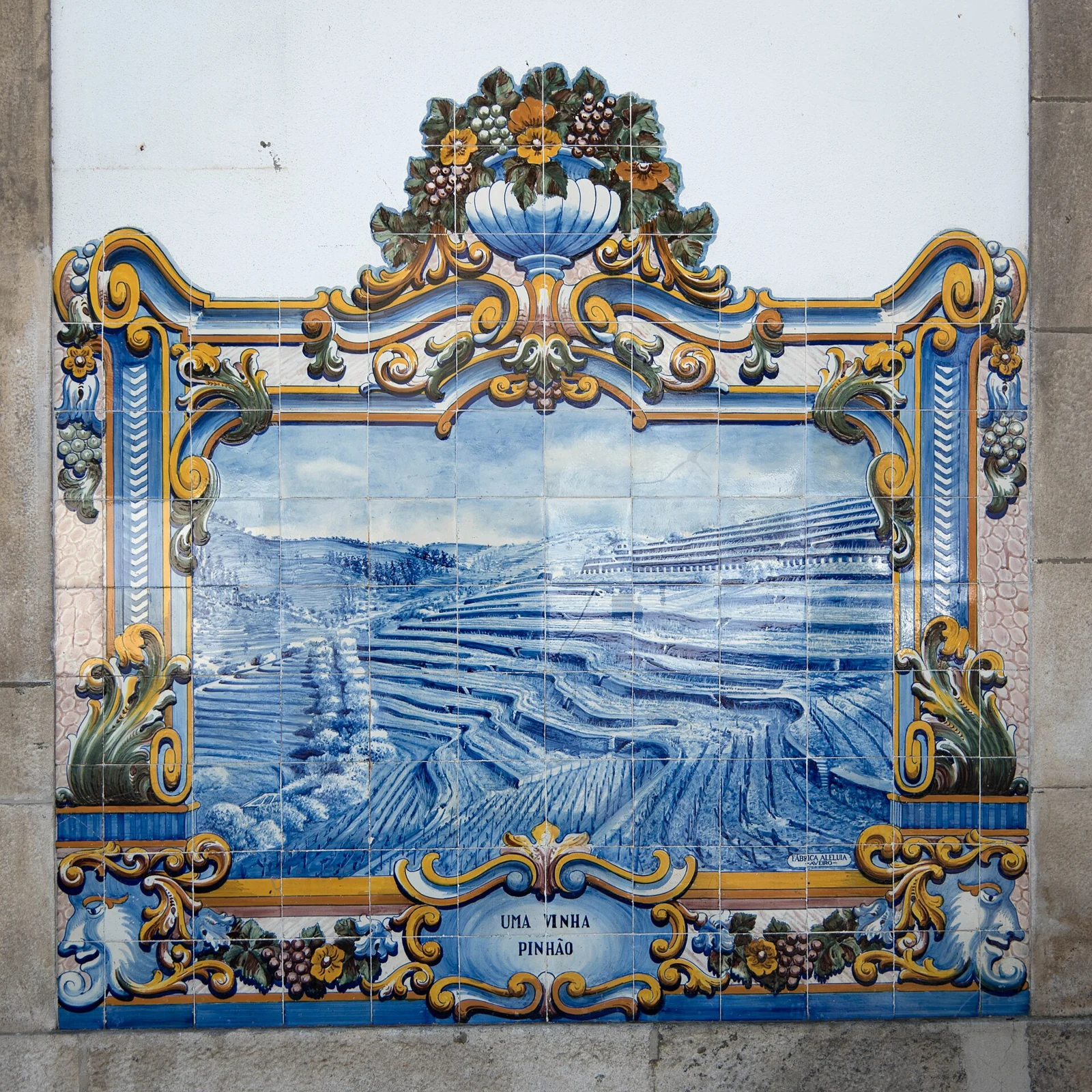A blue-and-yellow tiled vineyard scene on the wall of Pinhão railway station