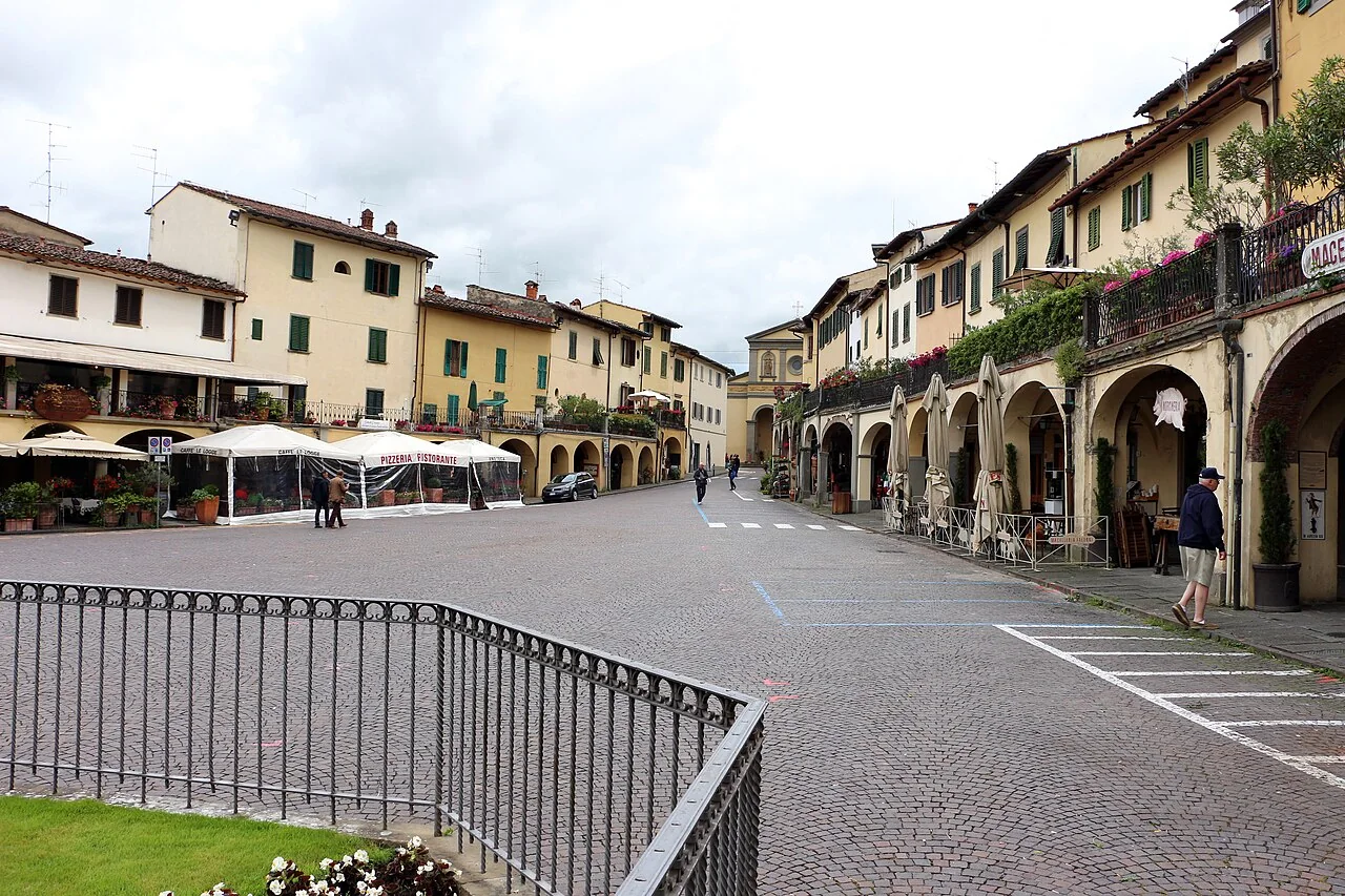 The main square in Greve in Chianti, with arcaded buildings, cafés and cobbled paving