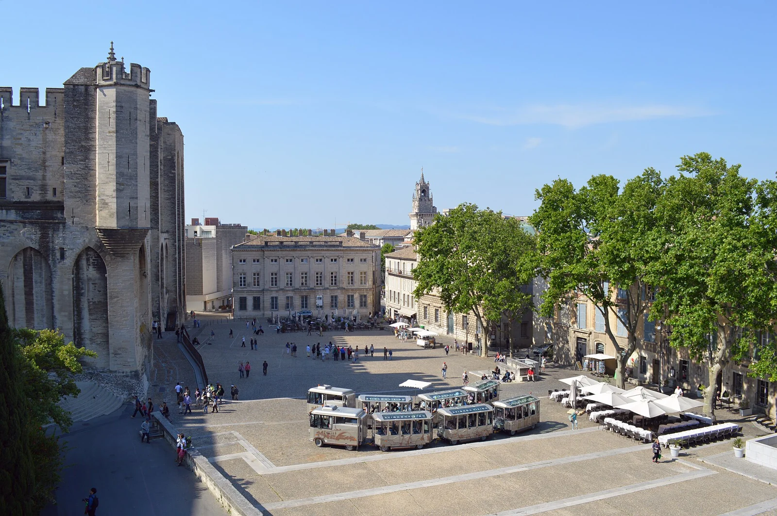People and café terraces around Place du Palais in Avignon