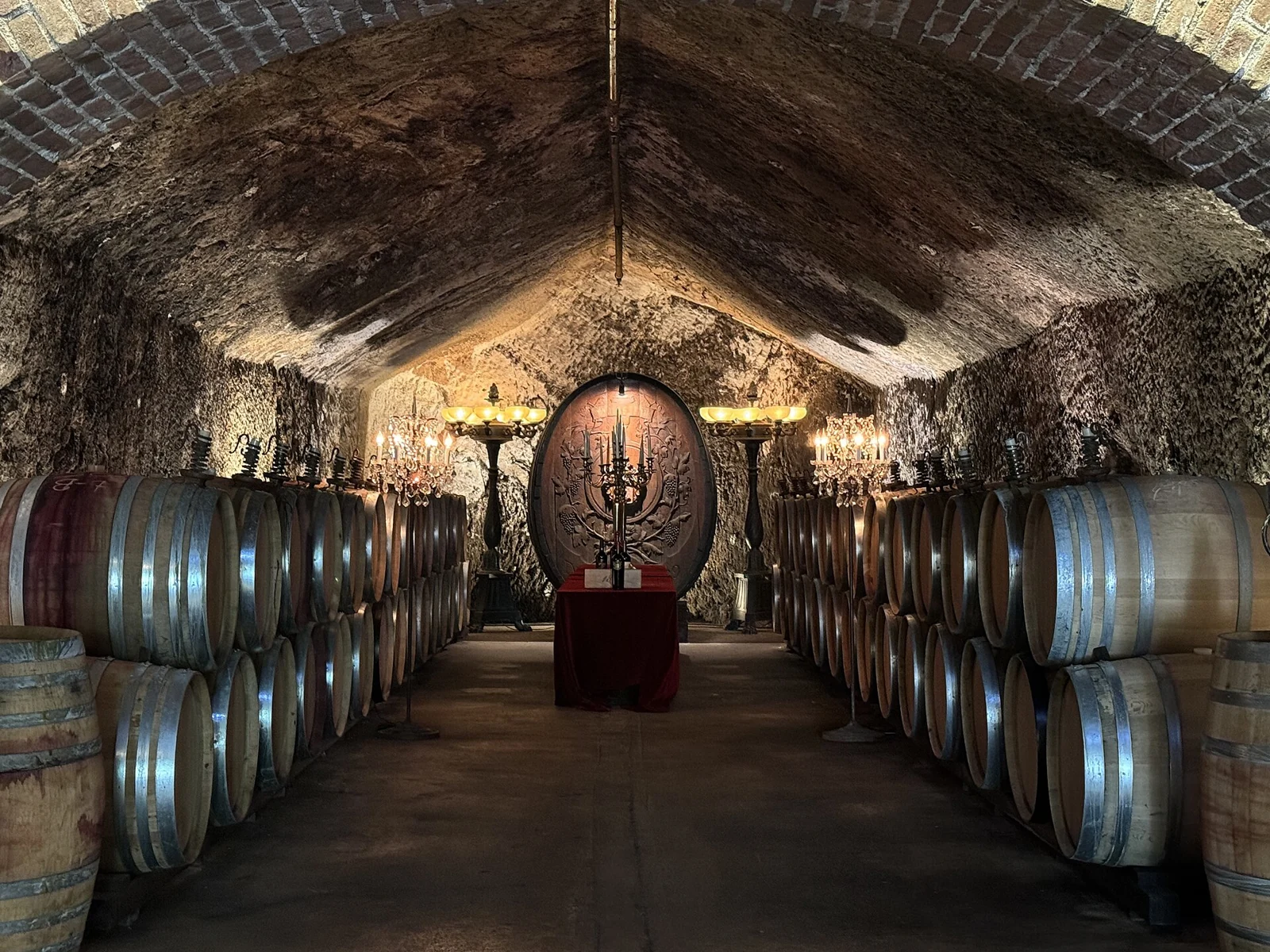 Barrels lining a stone-vaulted wine cave at Buena Vista Winery