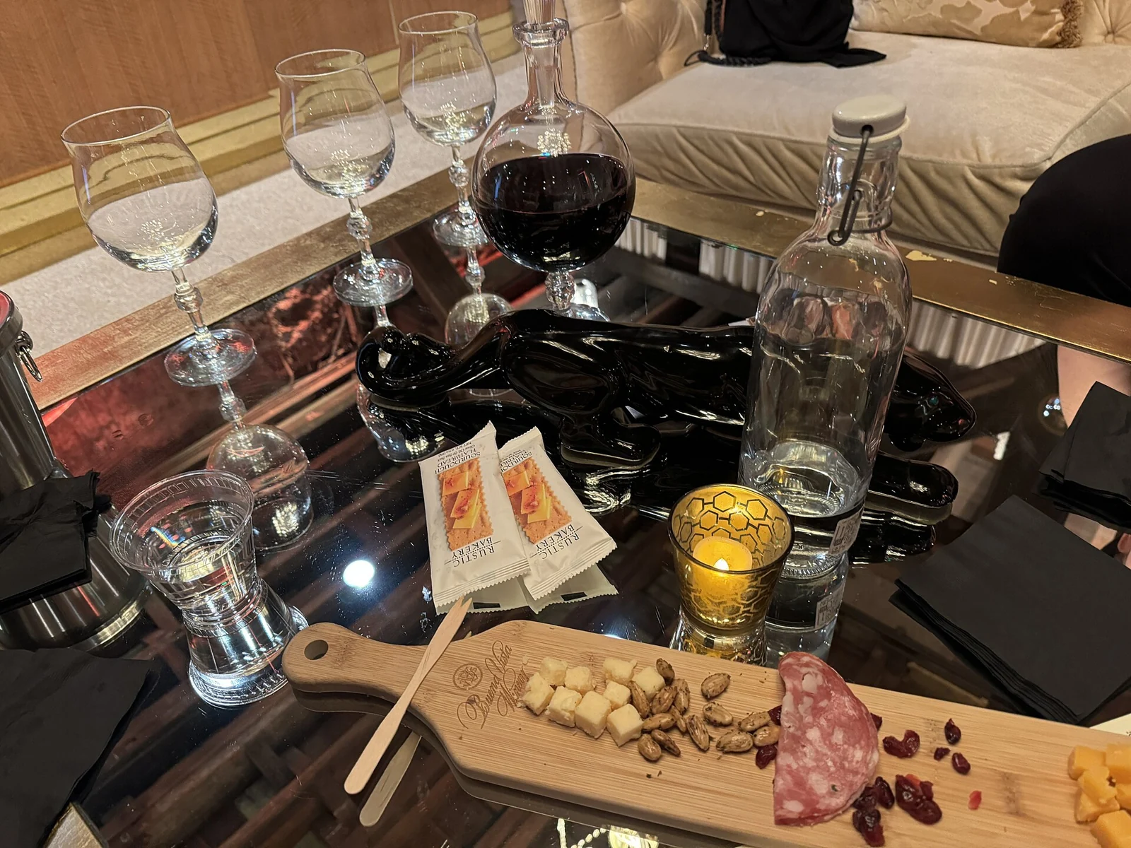 A table with a wine decanter, tasting glasses and a cheese board at Buena Vista Winery