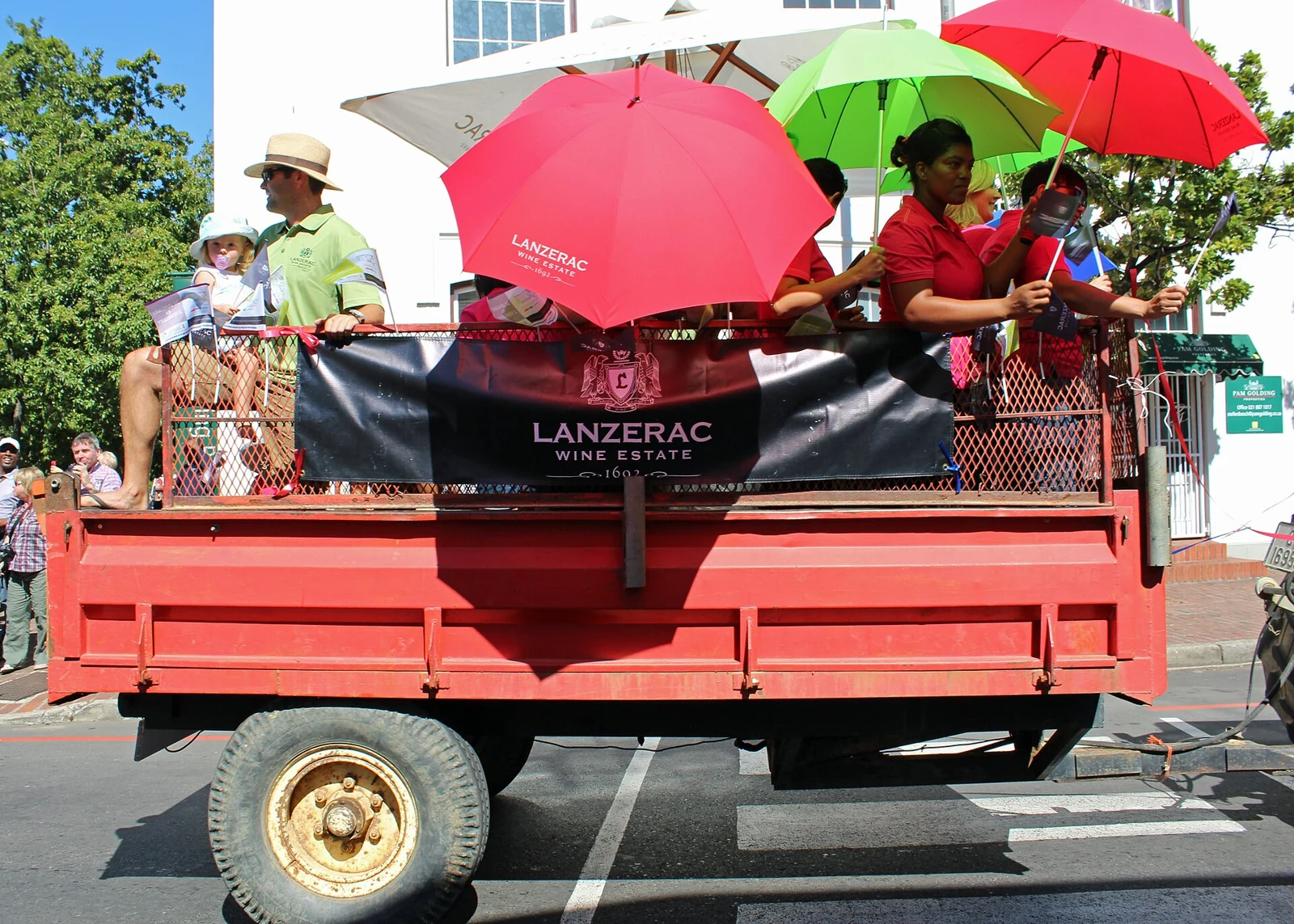 People riding on a Lanzerac float at the Stellenbosch harvest parade in 2014