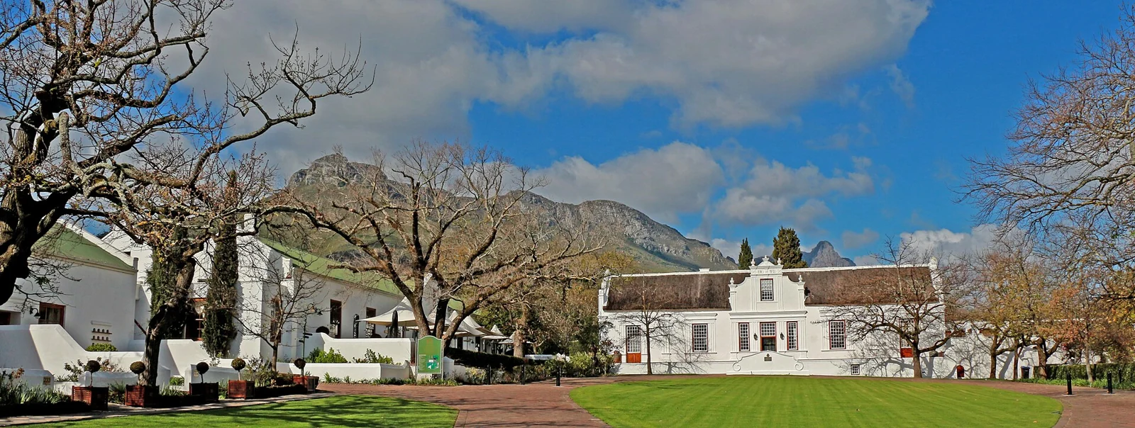 White historic buildings and mountains at Lanzerac Estate